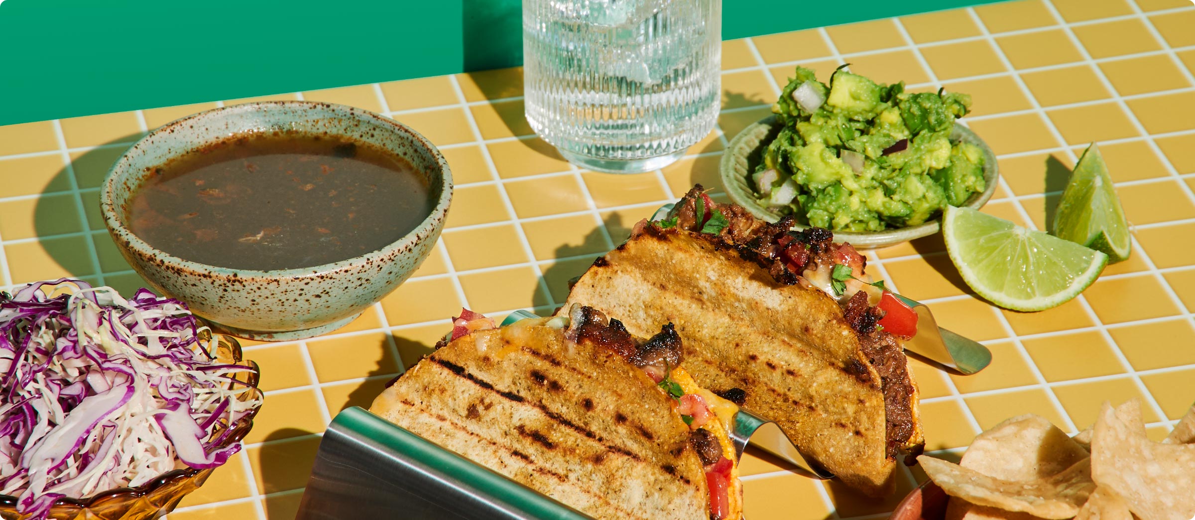 A Salsas spread — grilled tacos, guacamole, lime, slaw and chips